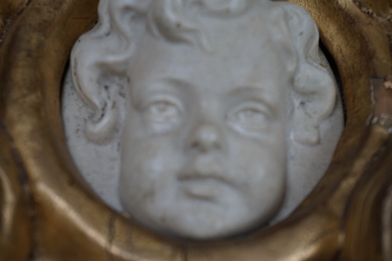 Italian pair of cherub reliefs in gilded wood framesSOLD