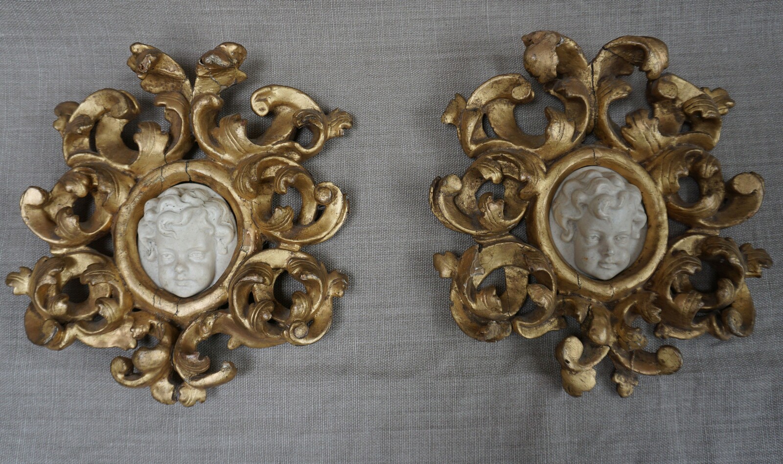 Italian pair of cherub reliefs in gilded wood framesSOLD