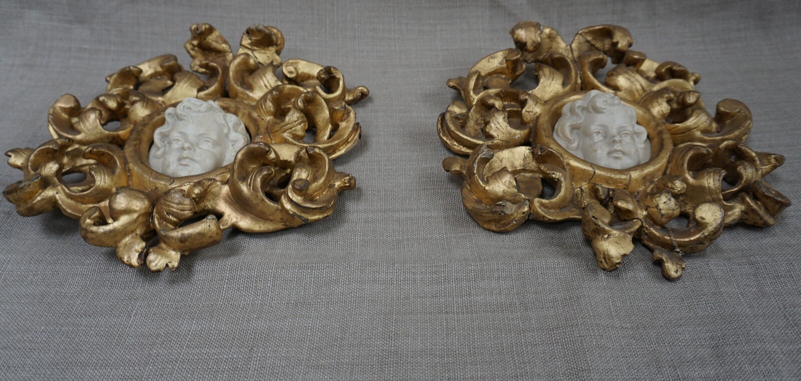 Italian pair of cherub reliefs in gilded wood framesSOLD