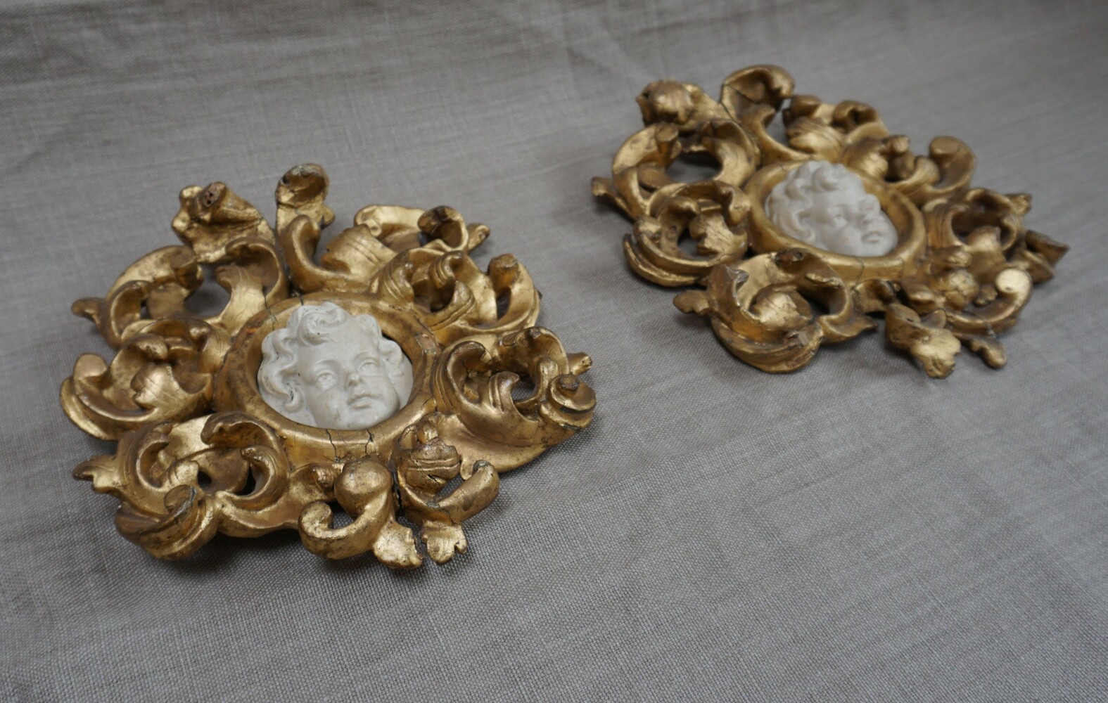 Italian pair of cherub reliefs in gilded wood framesSOLD
