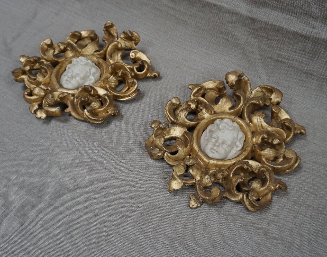 Italian pair of cherub reliefs in gilded wood framesSOLD