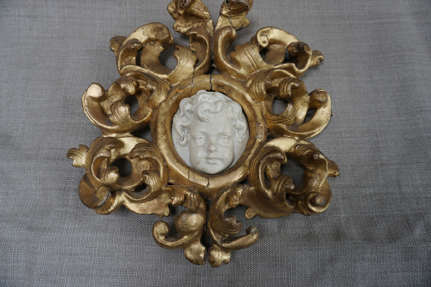 Italian pair of cherub reliefs in gilded wood framesSOLD